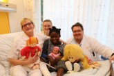 Zuneigung hilft! Kinderkrankenschwester Lisa Disse (von links), Praktikantin Leann Spieker 
und Unfallchirurg Frank Blömker kümmern sich mit Hingabe um die kleine Isabella aus 
Angola, die seit einem Unfall unter einem krummen Bein leidet.  Foto: 
Katholische Hospitalvereinigung Weser-Egge gGmbH
