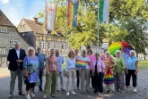 Bürgermeister Daniel Hartmann und Vertreterinnen und Vertreter des Bündnisses für Demokratie und Vielfalt vor der Regenbogenfahne am Stadthaus. Bildquelle: Stadt Höxter