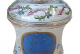 Historischer Deckelbecher aus farblosem Glas mit blauem Medaillon „Zum Andenken“, Blumenmalerei und goldfarbenen Verzierungen.