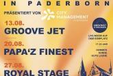 Gelb-blaues Veranstaltungsplakat „Donnerstags in Paderborn“ mit Live-Musik-Terminen am 13., 20. und 27. August auf dem Domplatz.