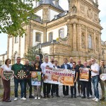 Die Oktobermarkt-Gemeinschaft rund um das Stadtmarketing Büren, die mitwirkenden Vereine, Institutionen und Sponsoren – ARGUS Additive Plastics GmbH, TG Umwelttechnik GmbH, Volksbank Büren-Salzkotten, Zweigniederlassung der VerbundVolksbank OWL eG, Warsteiner Brauerei und Westenergie – präsentieren das diesjährige Programm für das Wochenende vom 25. bis zum 28. September. Neu in diesem Jahr ist u. a. das Weindorf im Bereich der Jesuitenkirche. Foto: Stadt Büren